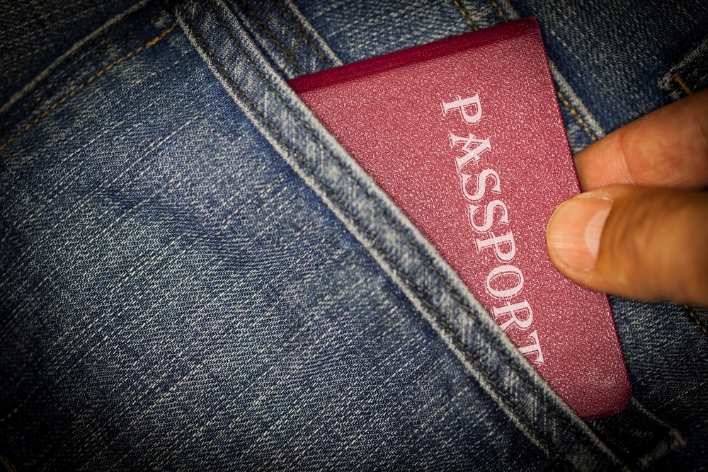 a traveller's passport in the pocket of their jeans