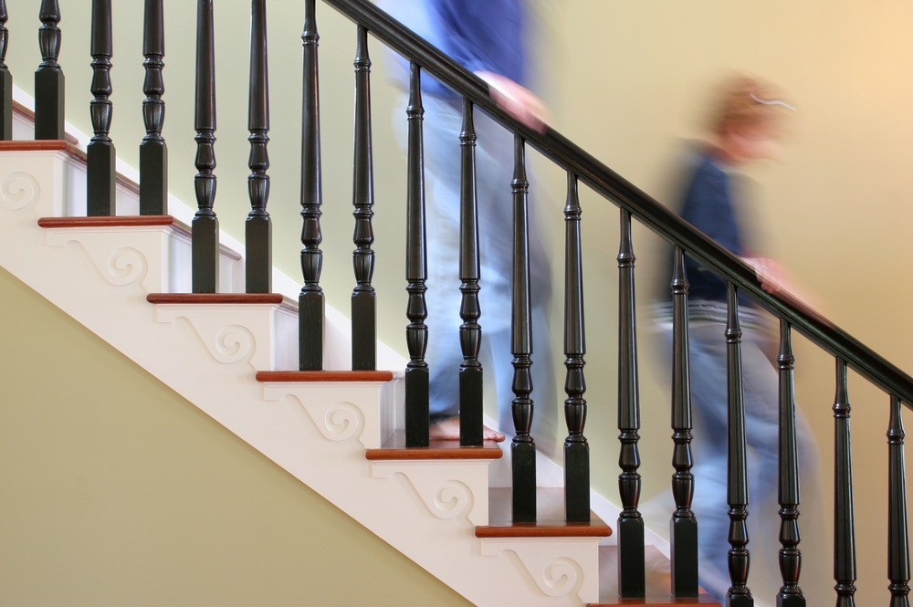 person walking down the stairs in a house