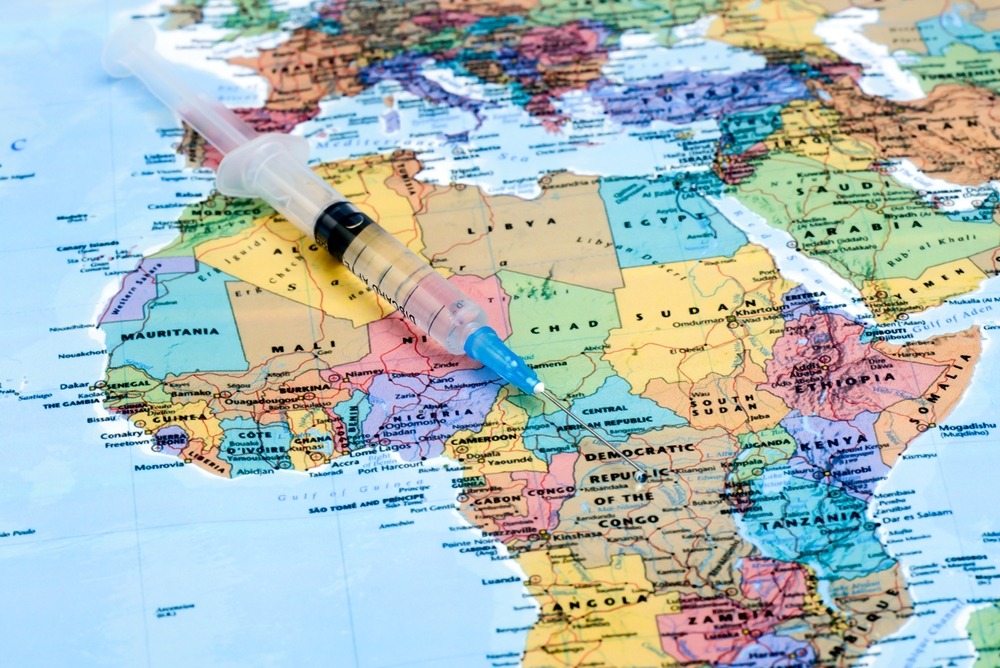 Map of Africa with a vaccine syringe resting on it