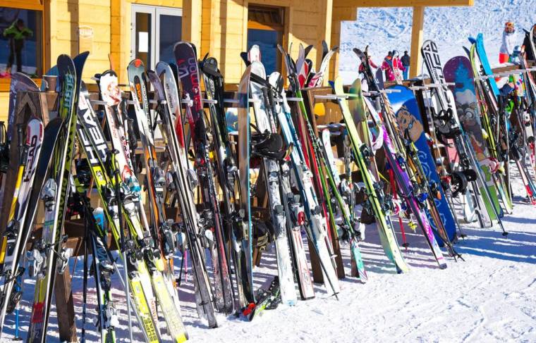 Skis stored outside a chalet in the snow