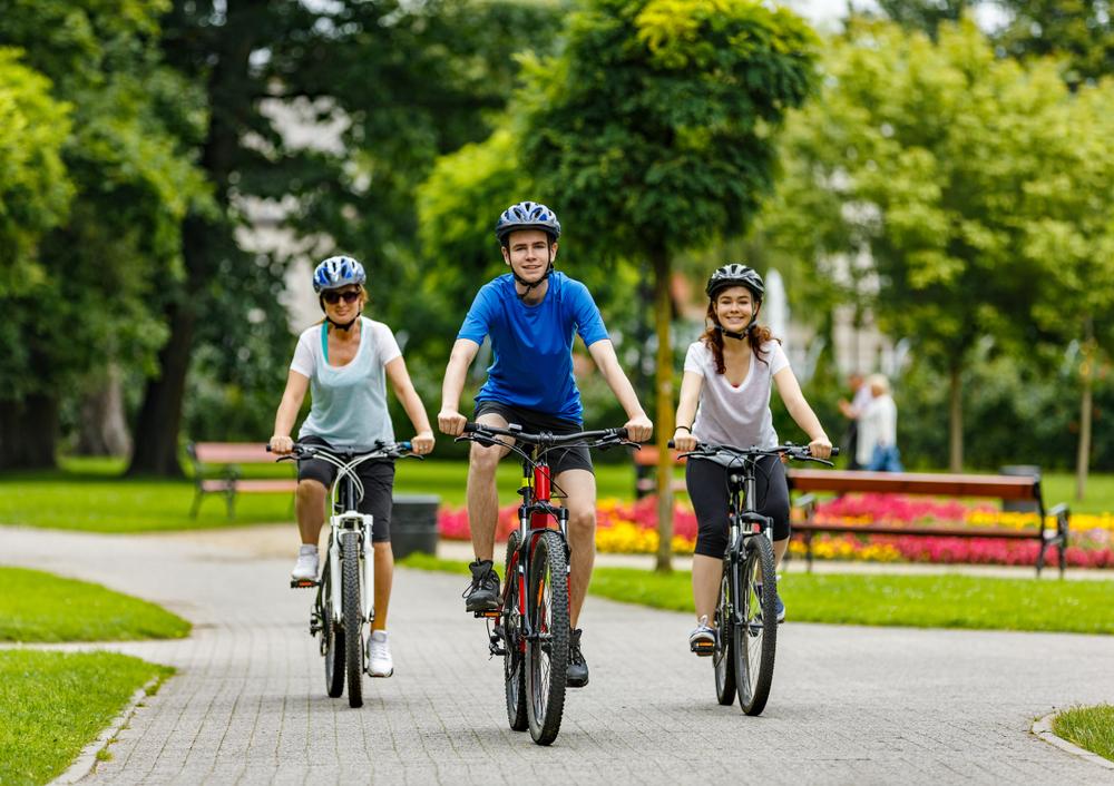 Three young cyclists in a park