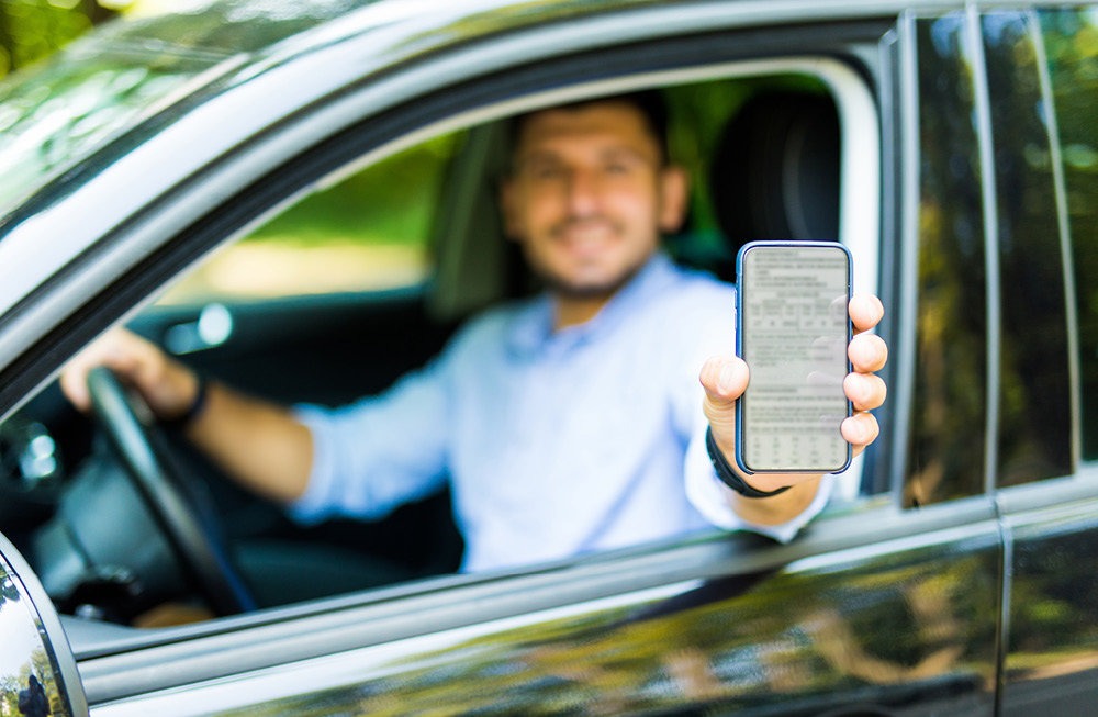 Driver showing their green card on a smartphone