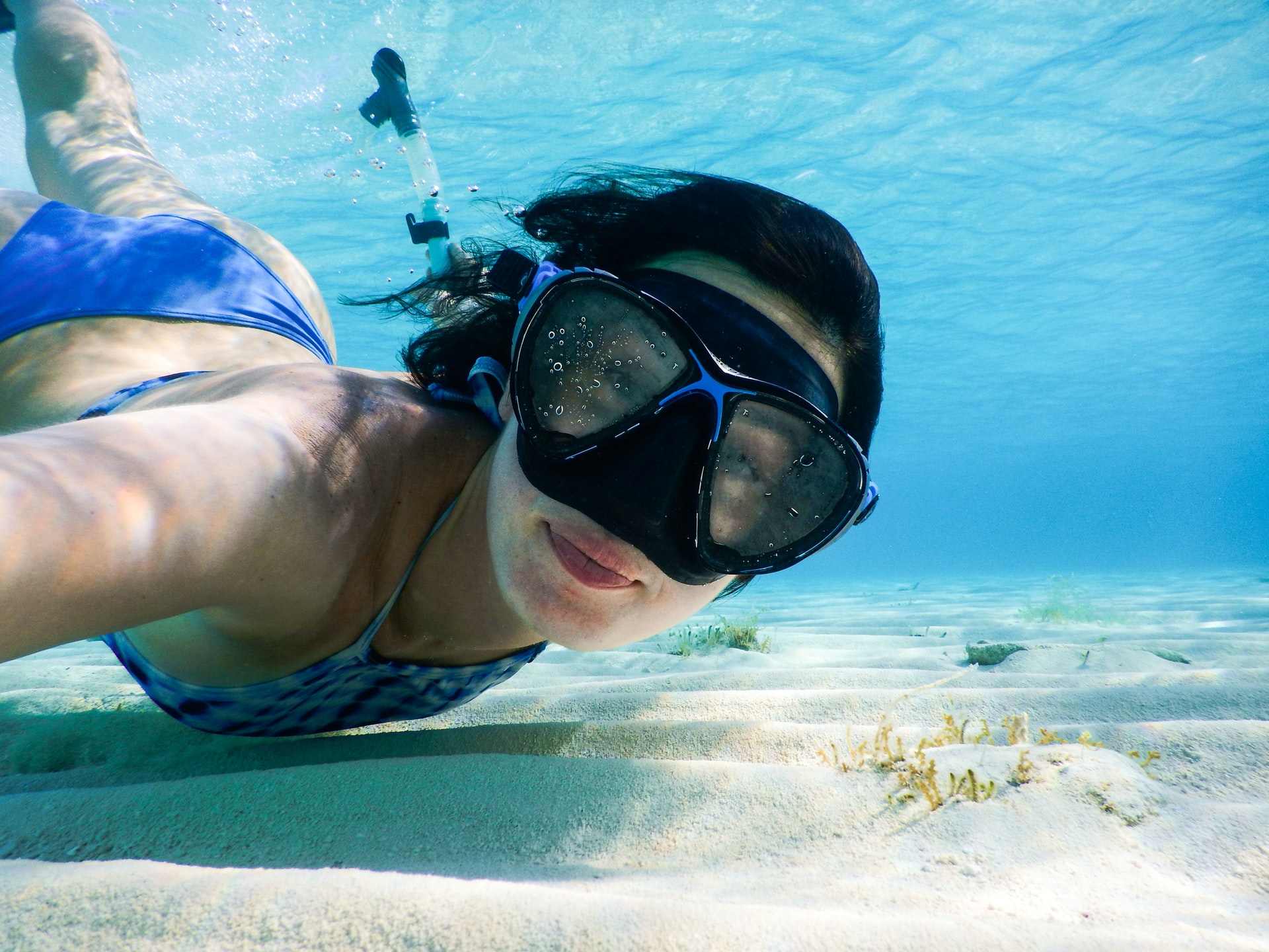 Young woman diving with a mask in the Mediterranean