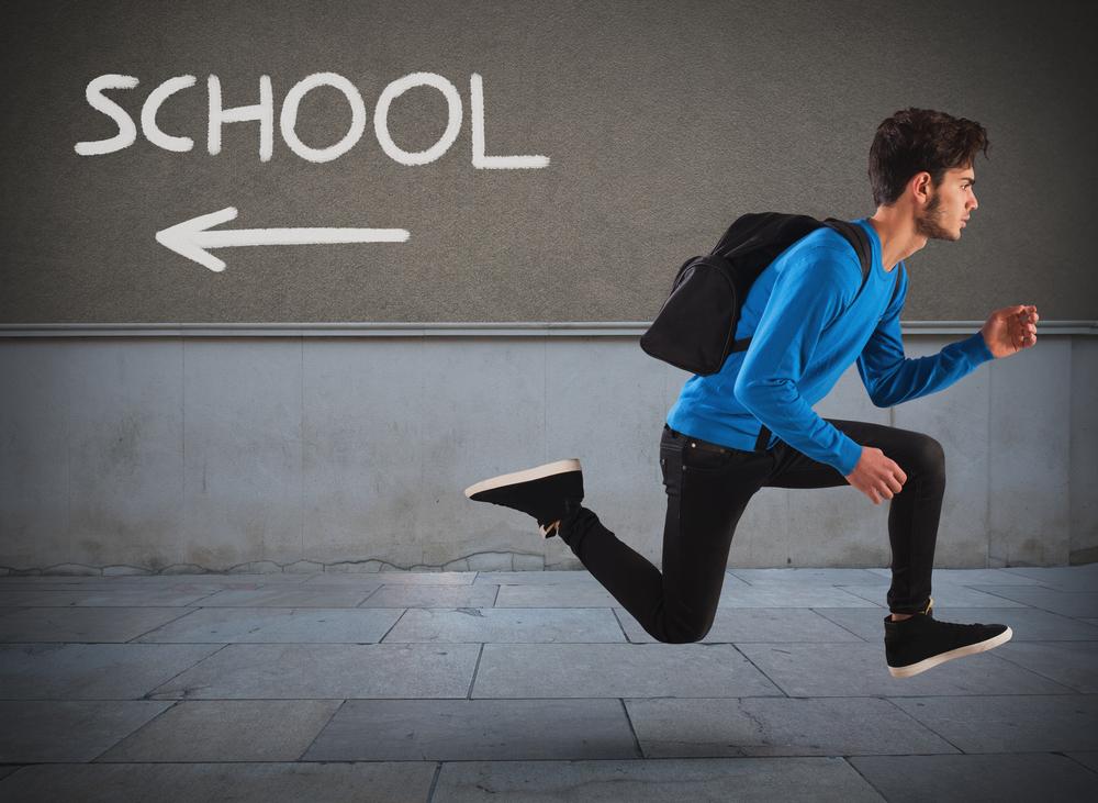 Student running in the opposite direction from their school