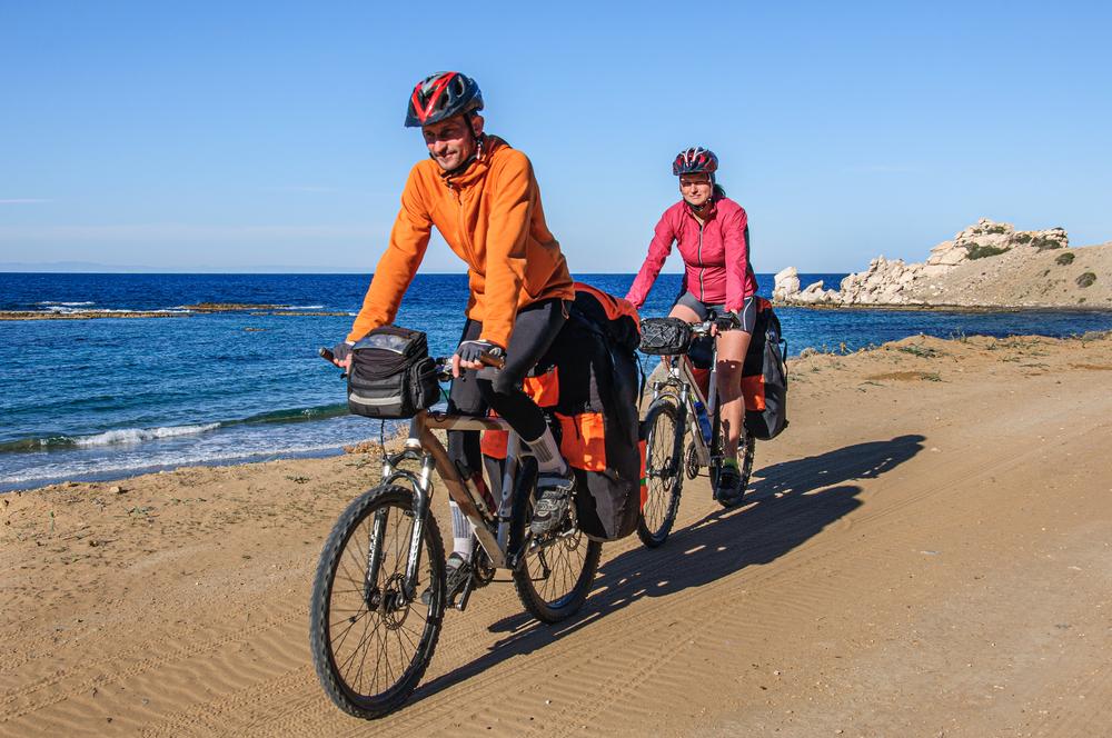 couple travelling by bike along the coast