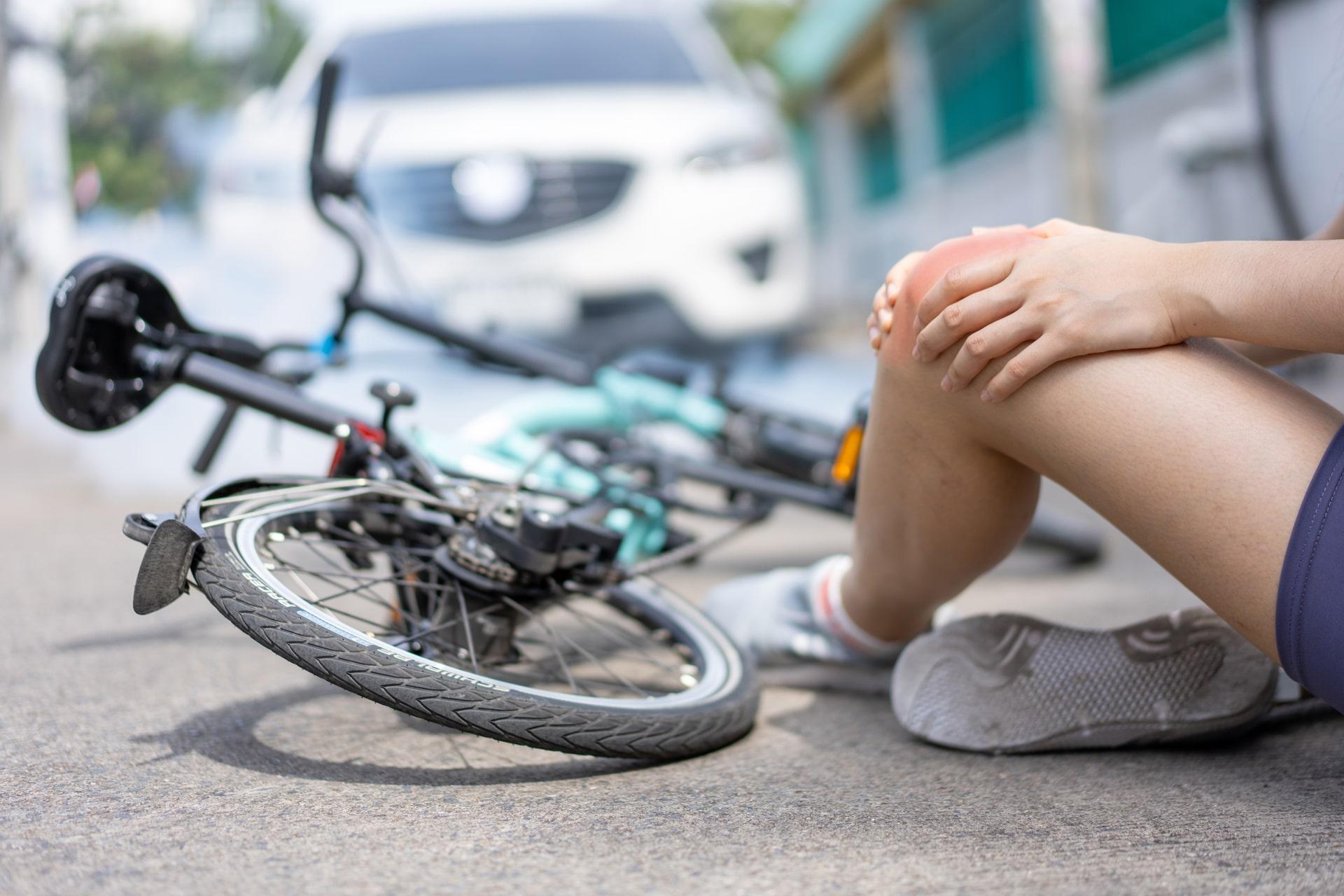 A young cyclist knocked down by a car on a public road