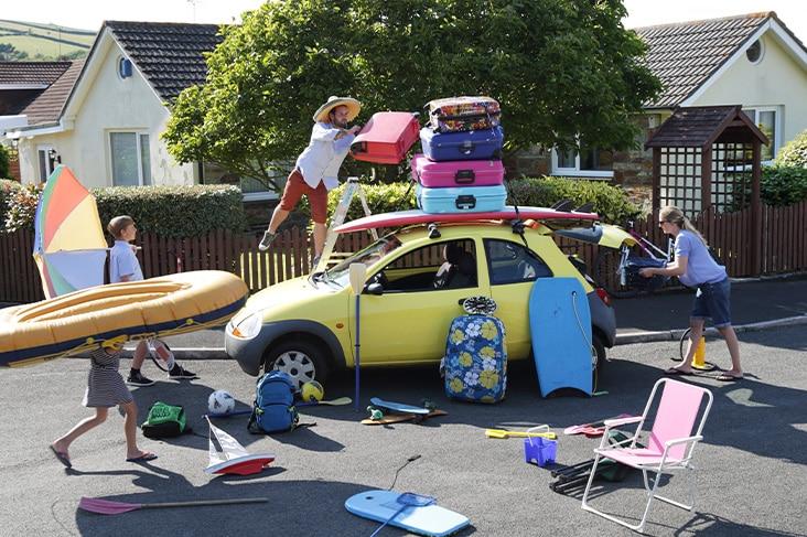 Family packing the car to leave on holiday